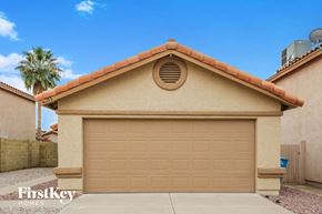 Phoenix house for rent - A beige house with a brown roof and a tan garage door.