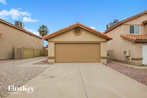 Phoenix house for rent - A beige garage door is the centerpiece of this residential scene.