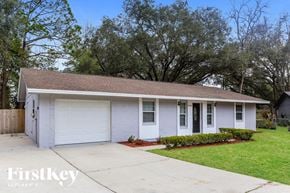 Jacksonville house for rent - A two-car garage with a white door and a brown roof.