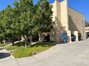San Diego apartment for rent - A large building with a tree in front of it.