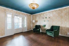 Shaker Heights apartment for rent - a living room with two green chairs and a chandelier