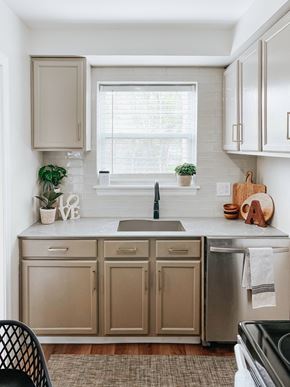 Shaker Heights apartment for rent - a kitchen with white cabinets and a sink and a window