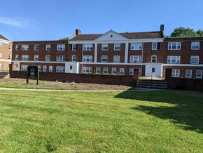 Shaker Heights apartment for rent - a large brick building with green grass in front of it