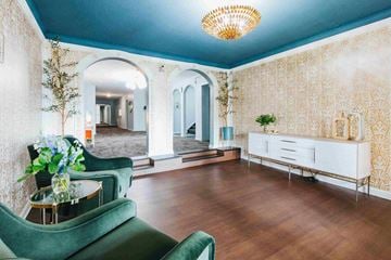 Shaker Heights apartment for rent - a living room with green furniture and a large mirror