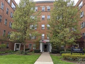 Shaker Heights apartment for rent - an apartment building with a sidewalk and trees in front of it