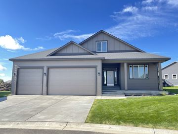 Spokane apartment for rent - a gray house with a garage door and a lawn