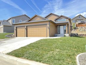 Spokane apartment for rent - a house with a garage door in front of a lawn