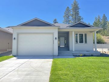 Spokane apartment for rent - a white house with a garage door and a lawn