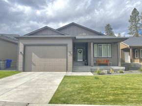 Spokane apartment for rent - a home with a garage door and a lawn