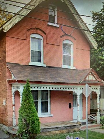 Ottawa apartment for rent - A red brick house with a white door and a small porch.