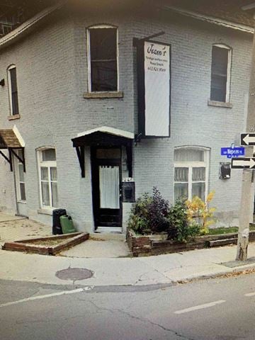 Ottawa apartment for rent - A white building with a black door and a sign that says "Vern's".
