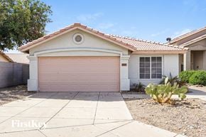 Goodyear house for rent - A house with a pink garage door is for sale.