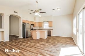Goodyear house for rent - A kitchen with wooden floors and a ceiling fan.