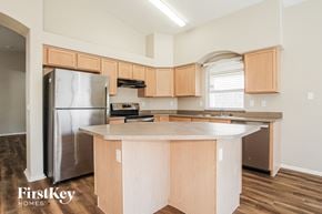 Goodyear house for rent - A kitchen with wooden cabinets and a stainless steel refrigerator.