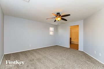 Gilbert house for rent - the living room has a ceiling fan and a carpet
