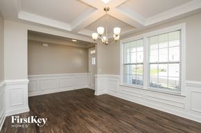 Mooresville house for rent - a dining room with white walls and a chandelier