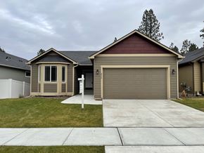 Spokane apartment for rent - a home with a driveway and a garage door