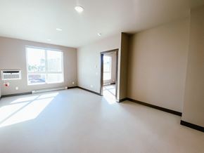 Watertown apartment for rent - A large, empty room with a doorway leading to another room.