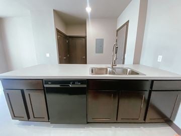 Watertown apartment for rent - A modern kitchen with a sink and a dishwasher.
