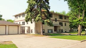 Fargo apartment for rent - a large house with a tree in front of it