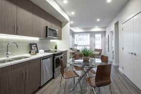 Calgary apartment for rent - A modern kitchen with a dining table and chairs.