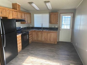 Grandview apartment for rent - A kitchen with black appliances and wooden cabinets.