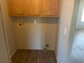 Grandview apartment for rent - A room with wooden floors and cabinets above it.