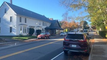 Camden apartment for rent - A red car is parked on the side of the road in front of a house.