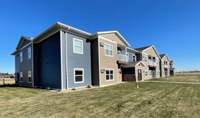 Devils Lake apartment for rent - a row of houses on a grass field