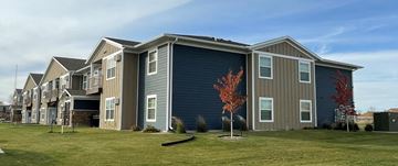 Devils Lake apartment for rent - a row of townhomes with a lawn in front of them