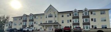 Devils Lake apartment for rent - a large apartment building with cars parked outside