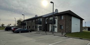 Devils Lake apartment for rent - an apartment building with cars parked in a parking lot
