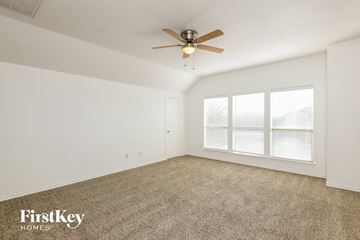Fort Worth house for rent - a living room with carpet and a ceiling fan