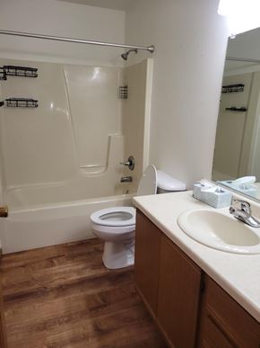 Weston apartment for rent - A white toilet in a bathroom with wooden floors.