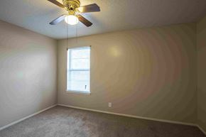 Temple apartment for rent - a bedroom with a ceiling fan and a window