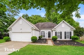 Indian Trail house for rent - A house with a white garage door is for sale.