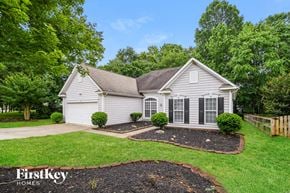 Indian Trail house for rent - A house with a well-maintained lawn and a FirstKey Homes logo.