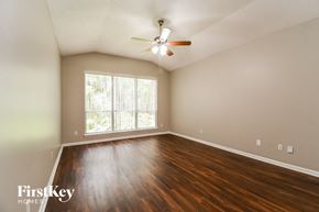 Fleming Island house for rent - the spacious living room with hardwood flooring and a large window