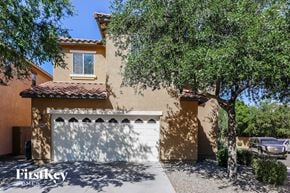 Phoenix house for rent - a house with a white garage door and a tree