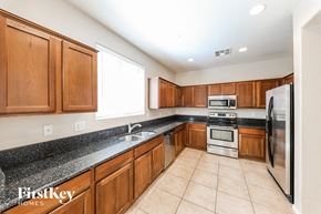Phoenix house for rent - a large kitchen with wooden cabinets and stainless steel appliances