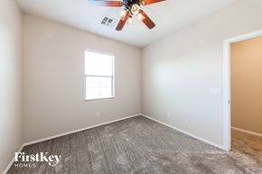 Phoenix house for rent - a bedroom with carpet and a ceiling fan