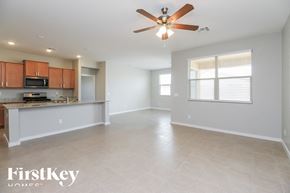 San Tan Valley house for rent - A spacious living room with a kitchen area in the background.