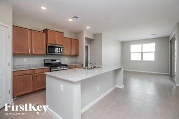 San Tan Valley house for rent - A kitchen with wooden cabinets and a white island.
