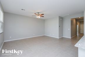 San Tan Valley house for rent - A spacious room with a ceiling fan and a tiled floor.