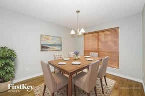 Denton house for rent - A dining room with a wooden table and chairs.