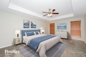 Denton house for rent - A bedroom with a bed, nightstands, and pictures on the wall.