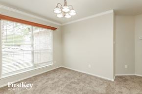 Converse house for rent - an empty bedroom with a large window and a chandelier