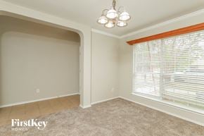 Converse house for rent - a dining room with a large window and a beige carpet