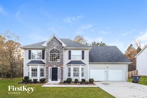 Stockbridge house for rent - a white house with a gray roof and white garage doors