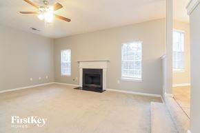 Stockbridge house for rent - a living room with a fireplace and a ceiling fan
